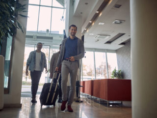 Group of young men in a hotel lobby - Journey House Travel