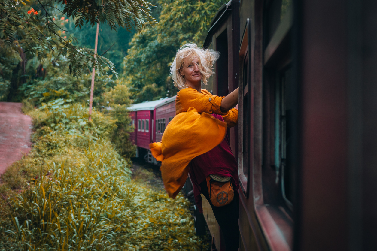 Tourist female enjoys a famous scenic train ride through Sri Lanka - Journey House Travel